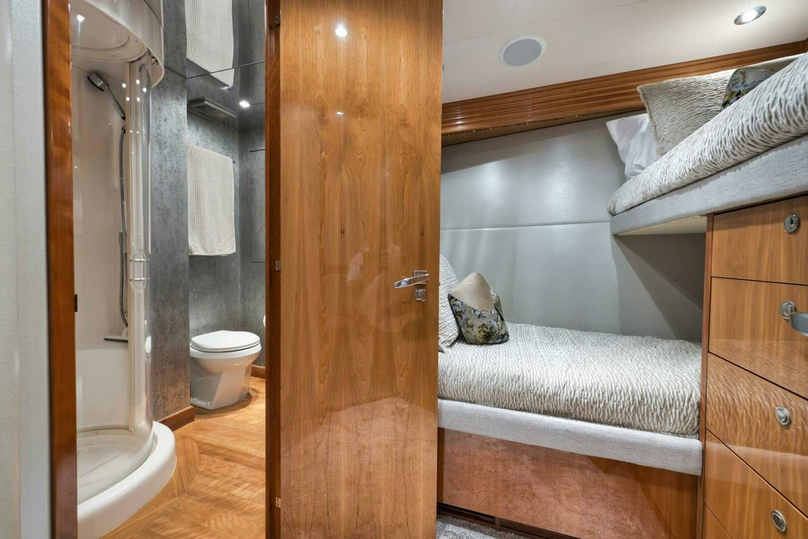 a bathroom with a bed and a wood door aboard REEL TRADER Yacht for Sale