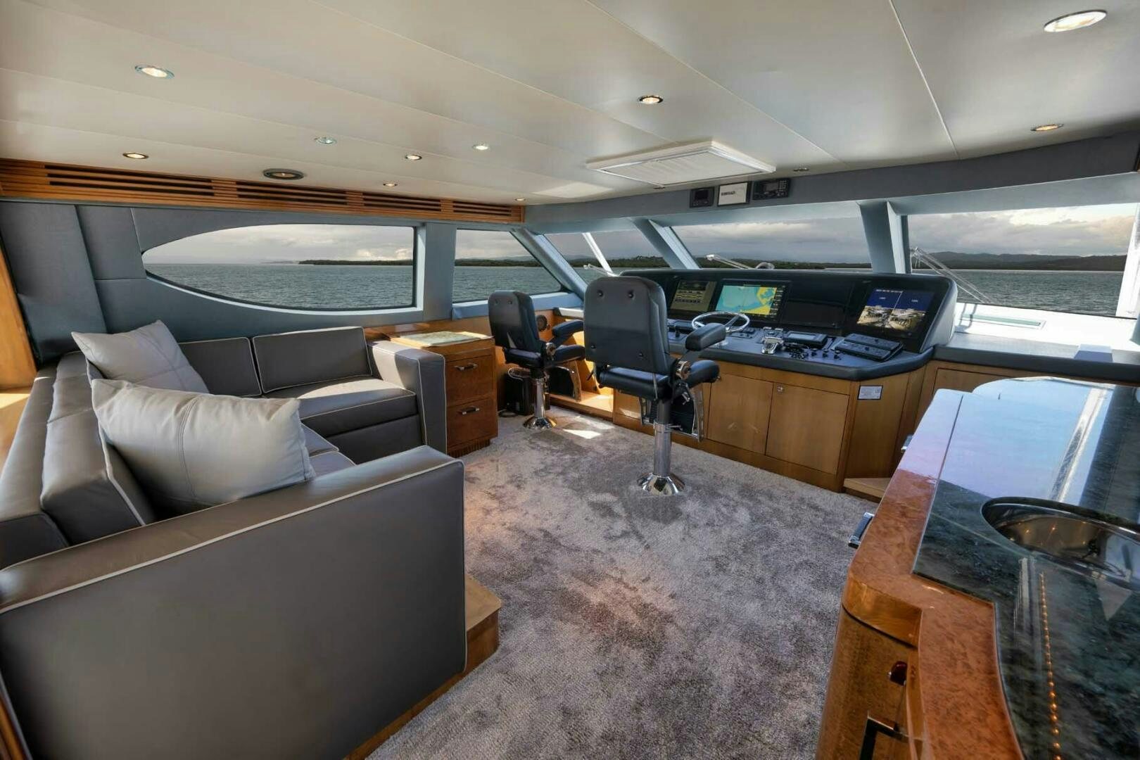 a room with a couch and a desk with a computer on it aboard REEL TRADER Yacht for Sale