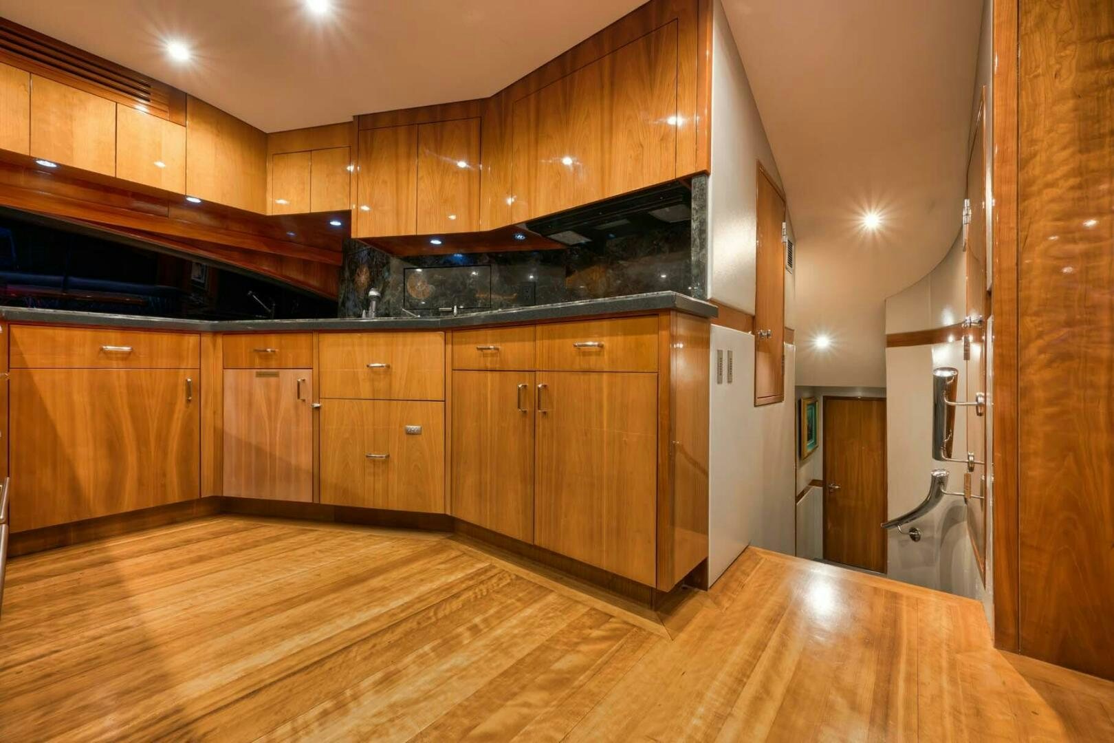 a large kitchen with wooden cabinets aboard REEL TRADER Yacht for Sale