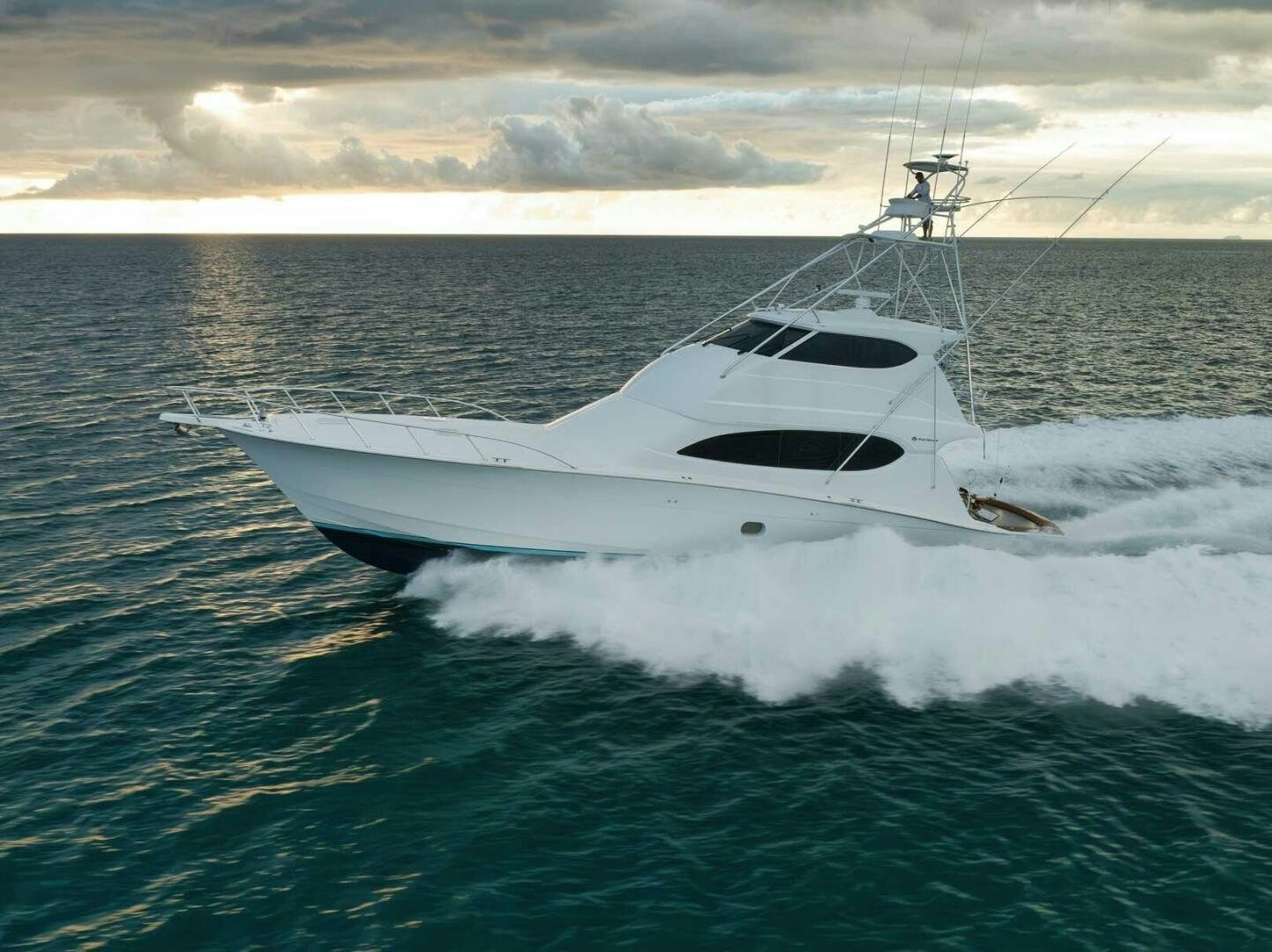 a white yacht in the water aboard REEL TRADER Yacht for Sale