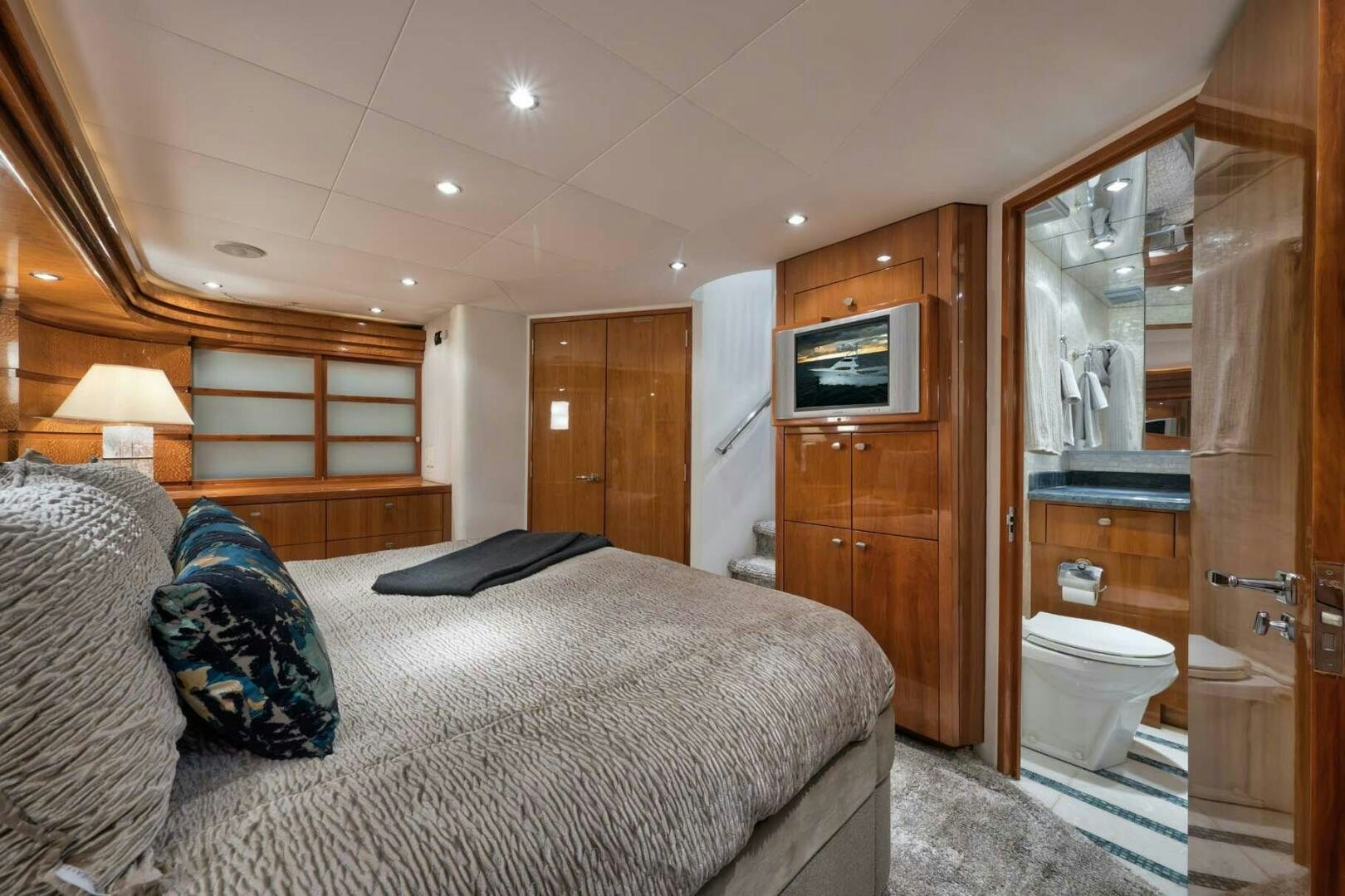 a bedroom with a bed and a television aboard REEL TRADER Yacht for Sale