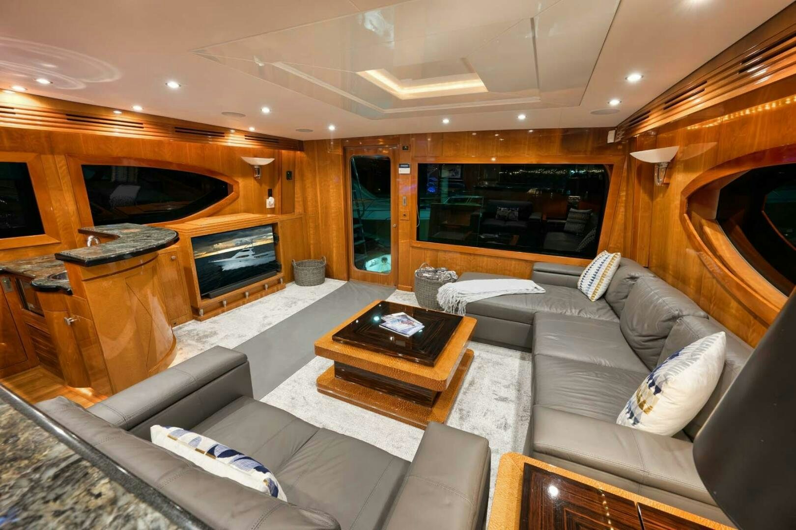 a living room with a fireplace aboard REEL TRADER Yacht for Sale