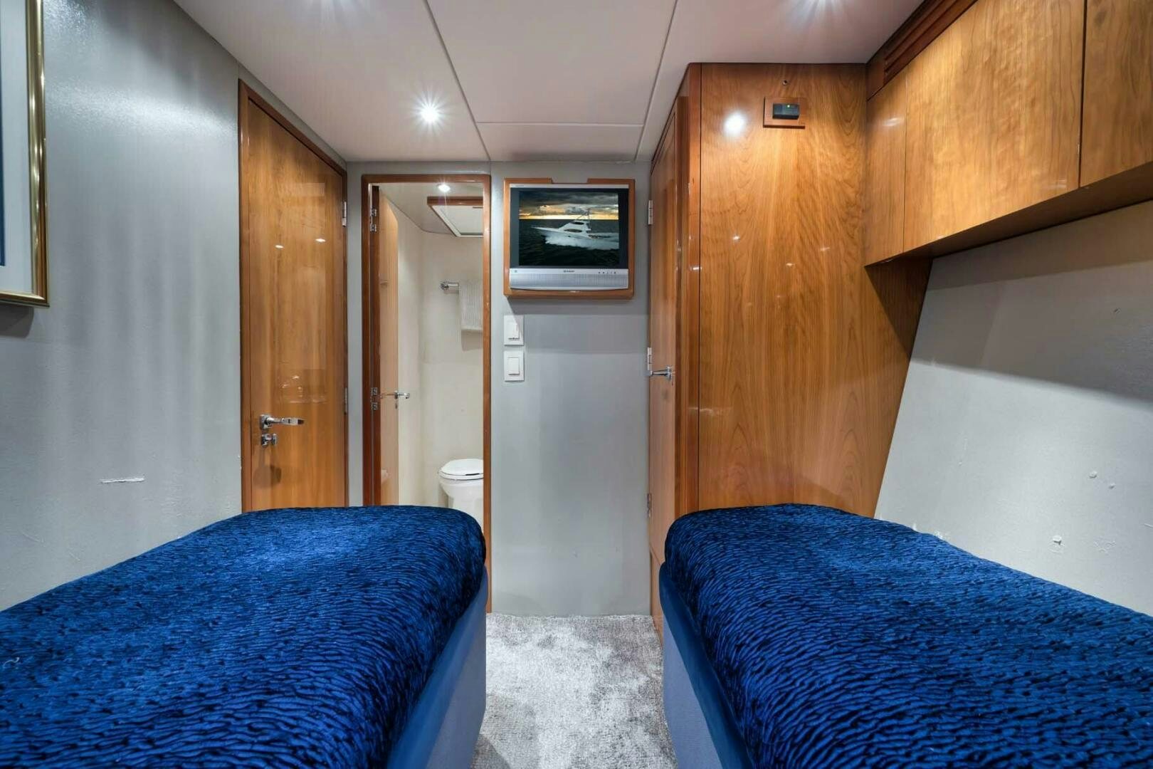 a bathroom with a blue bed aboard REEL TRADER Yacht for Sale