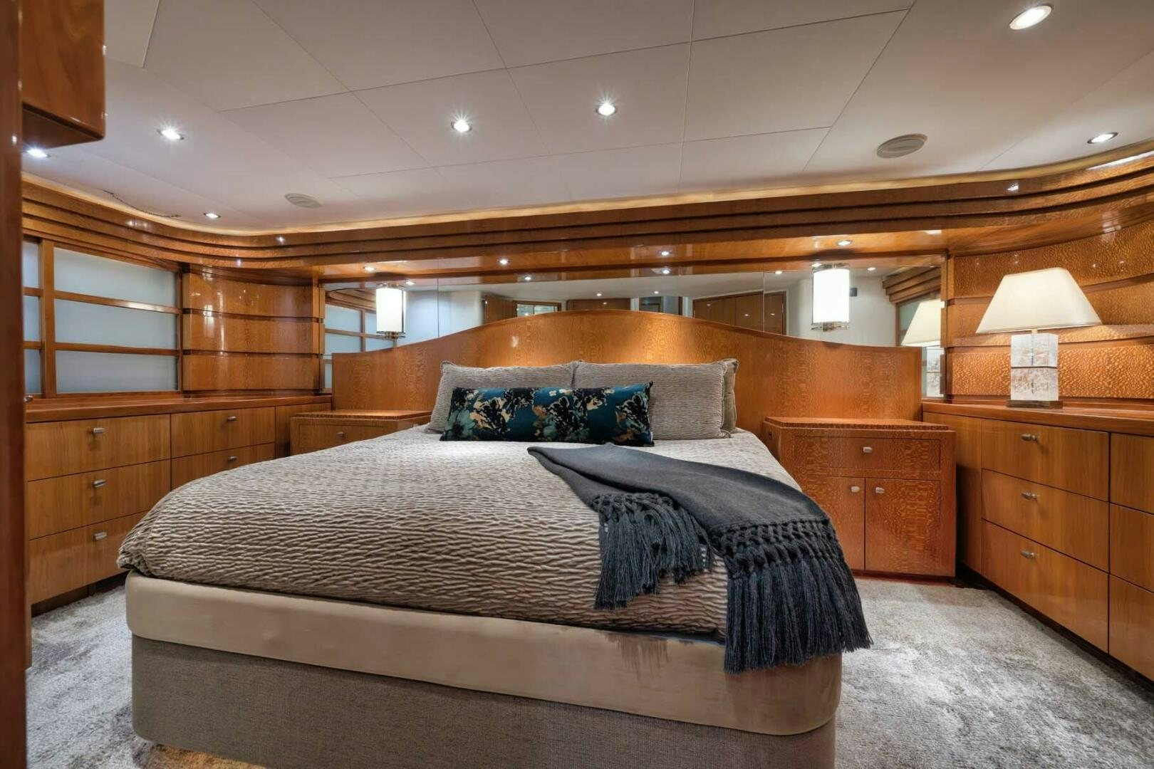 a bedroom with a bed and a wood wall aboard REEL TRADER Yacht for Sale