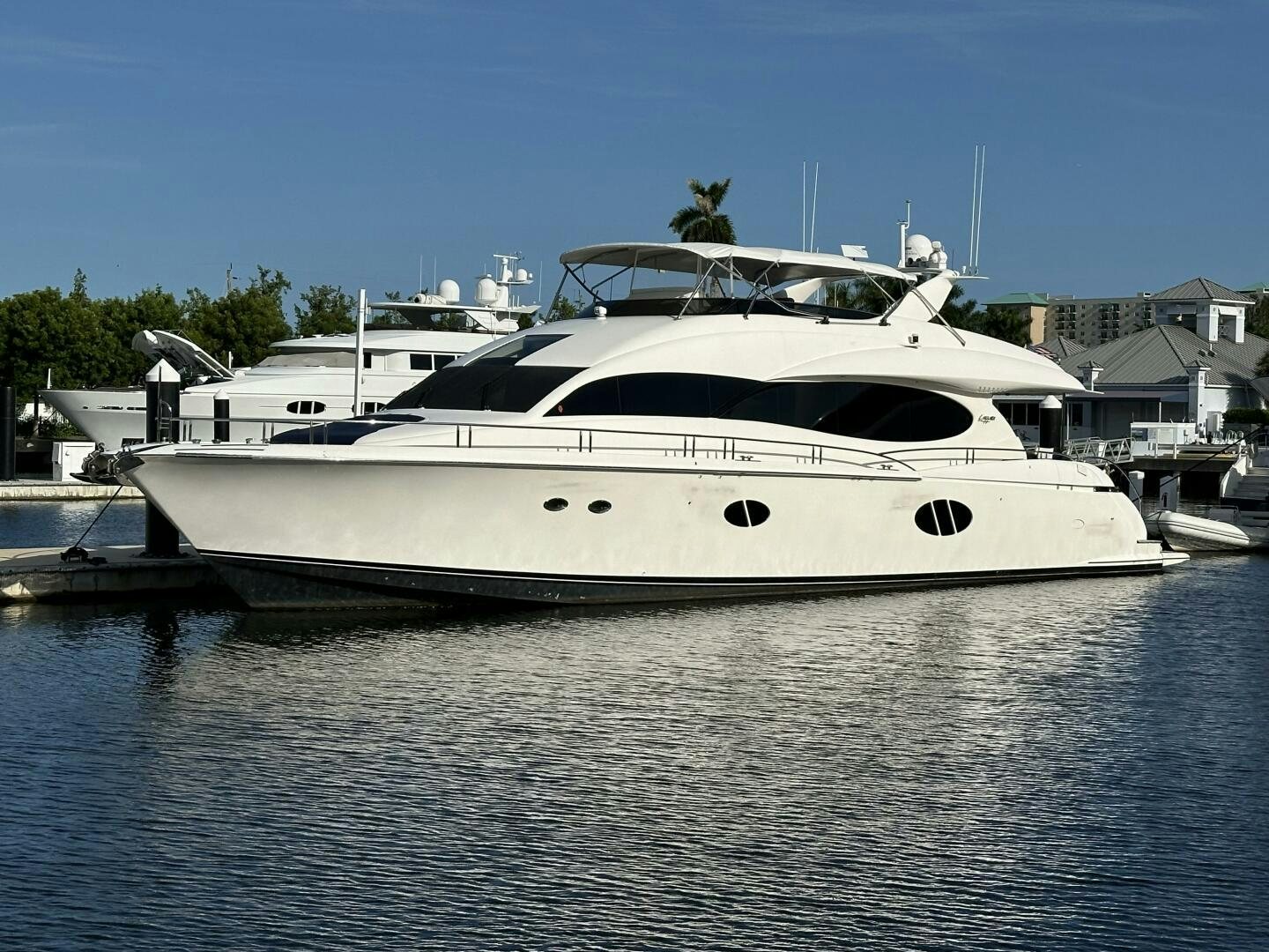 a white yacht in a harbor aboard CERCA TROVA Yacht for Sale