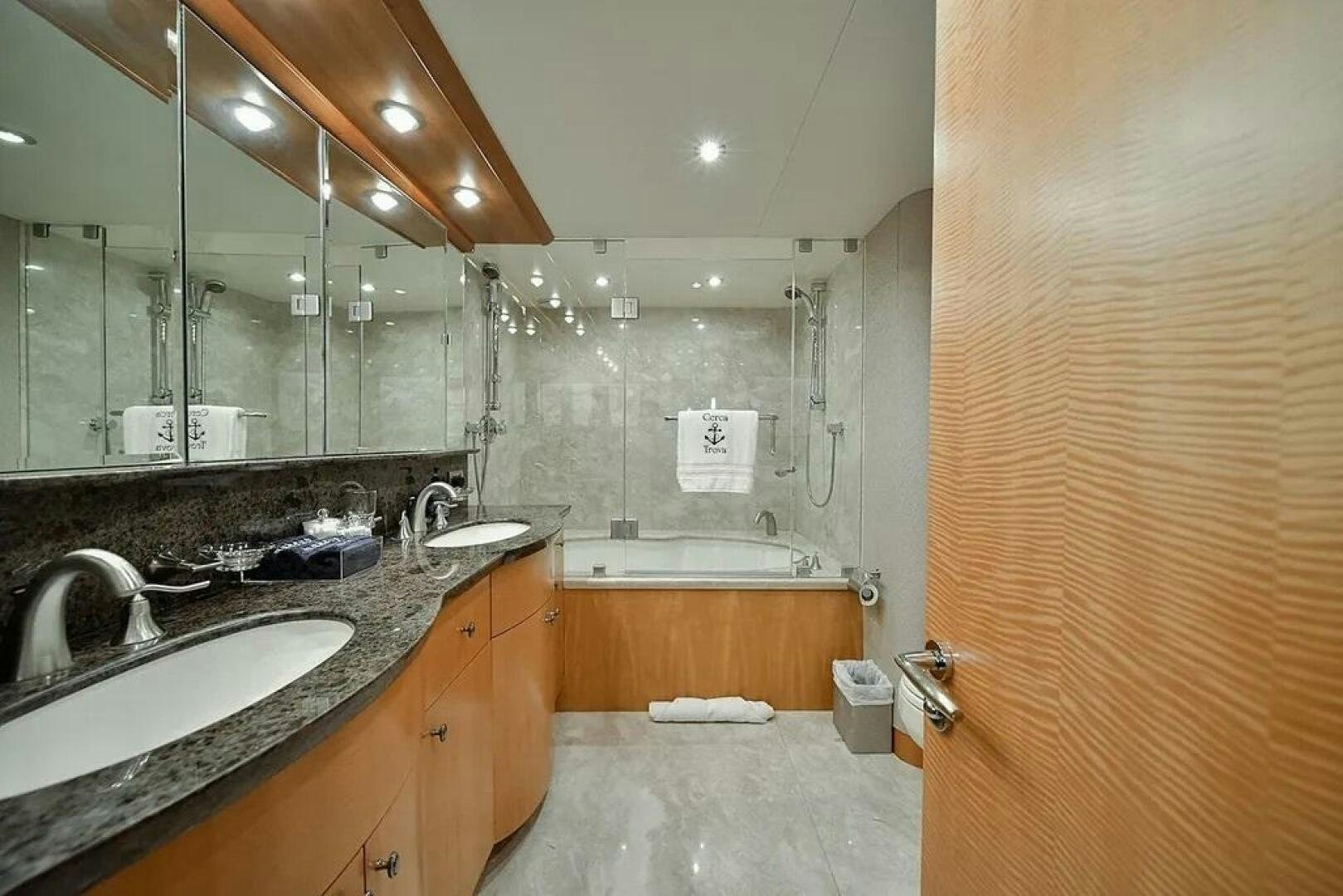 a bathroom with a large mirror aboard CERCA TROVA Yacht for Sale