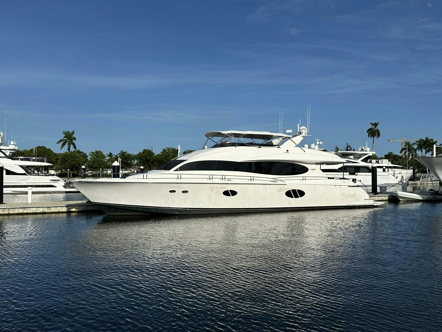 a white yacht in a harbor aboard CERCA TROVA Yacht for Sale