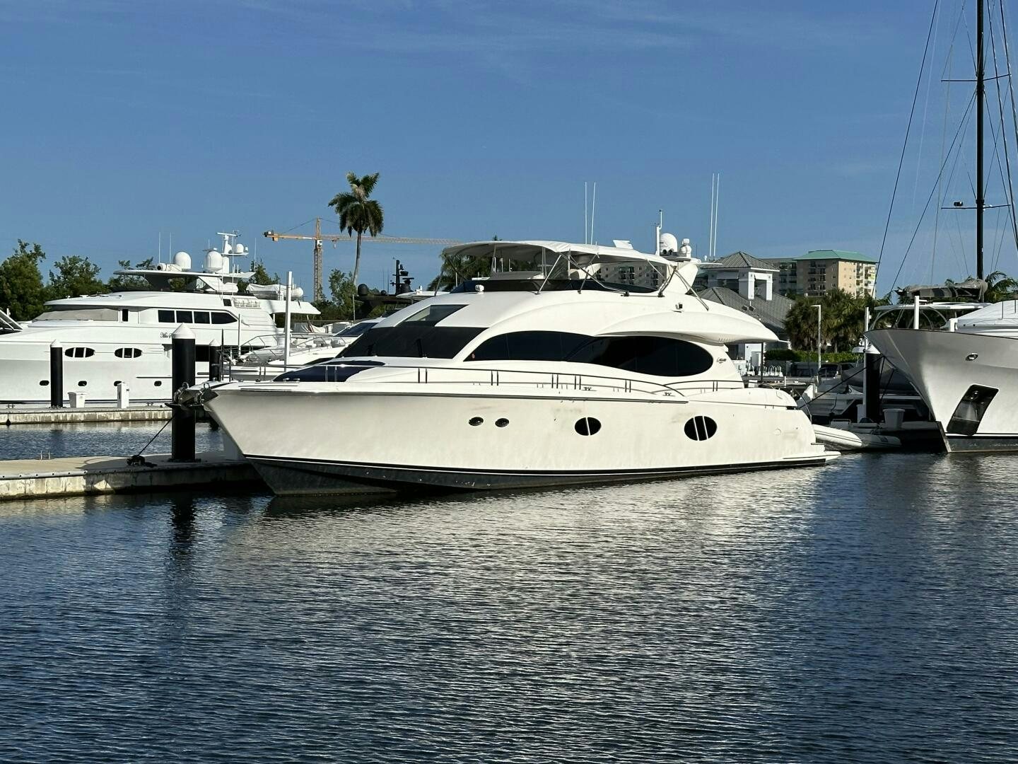 a white yacht in a harbor aboard CERCA TROVA Yacht for Sale