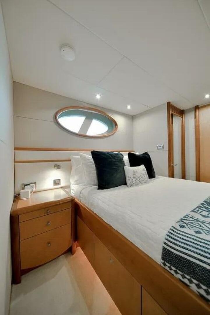 a bed with a mirror above it aboard CERCA TROVA Yacht for Sale