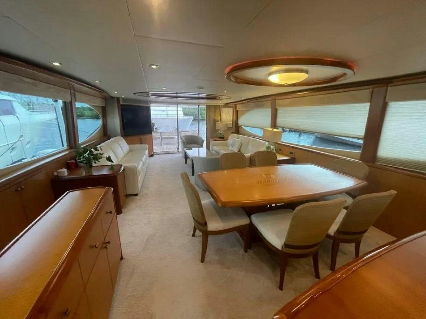 a living room with a table and chairs aboard CERCA TROVA Yacht for Sale