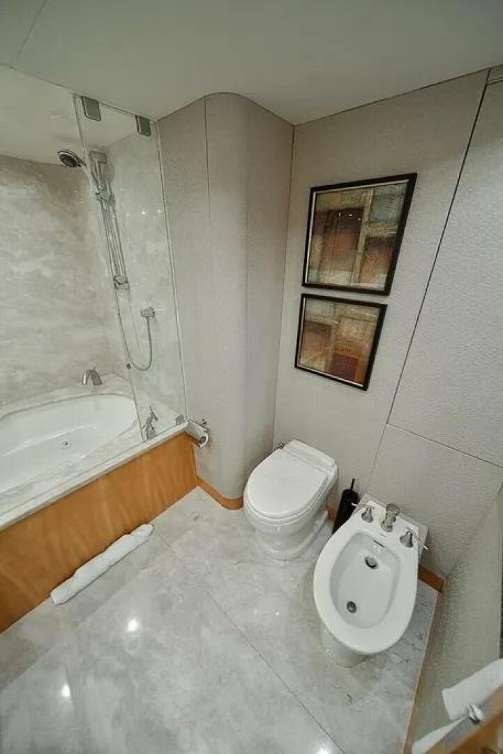 a bathroom with a toilet and tub aboard CERCA TROVA Yacht for Sale