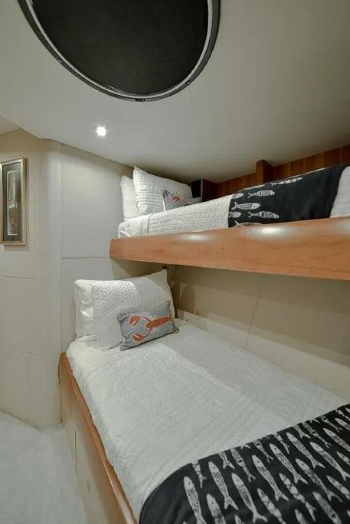 a bed with a mirror above it aboard CERCA TROVA Yacht for Sale