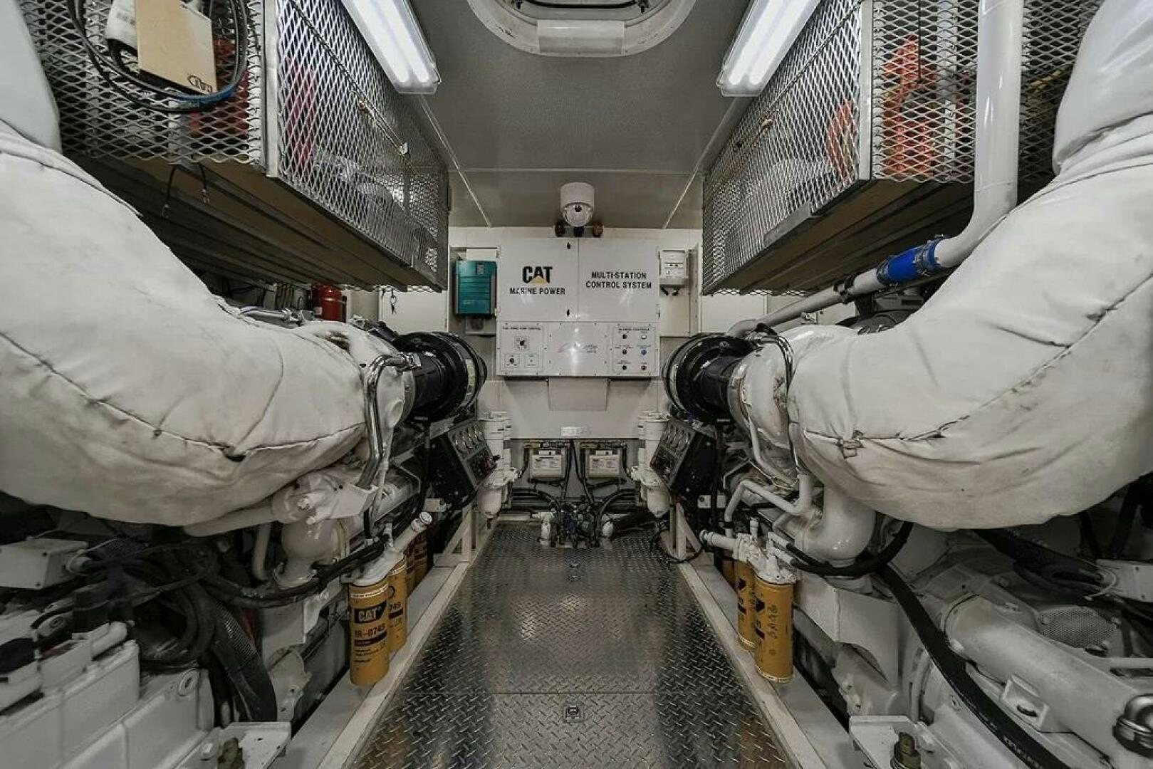 a person in a white suit in a room with white walls and a few machines aboard CERCA TROVA Yacht for Sale