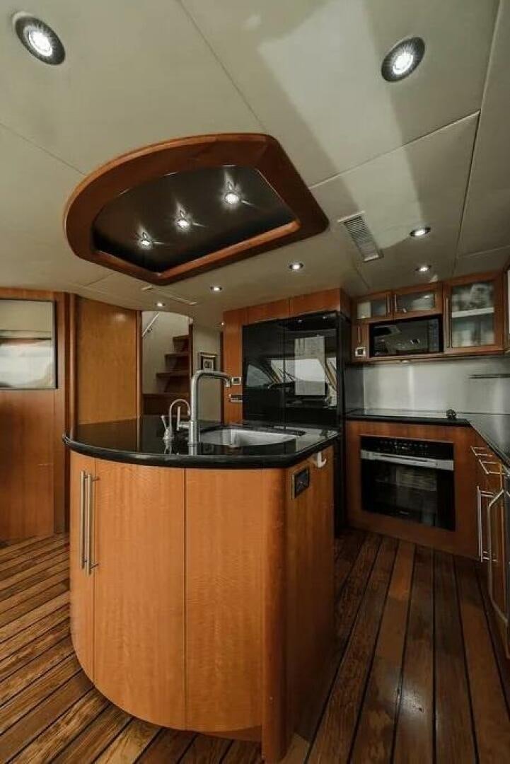 a kitchen with a wood floor aboard CERCA TROVA Yacht for Sale