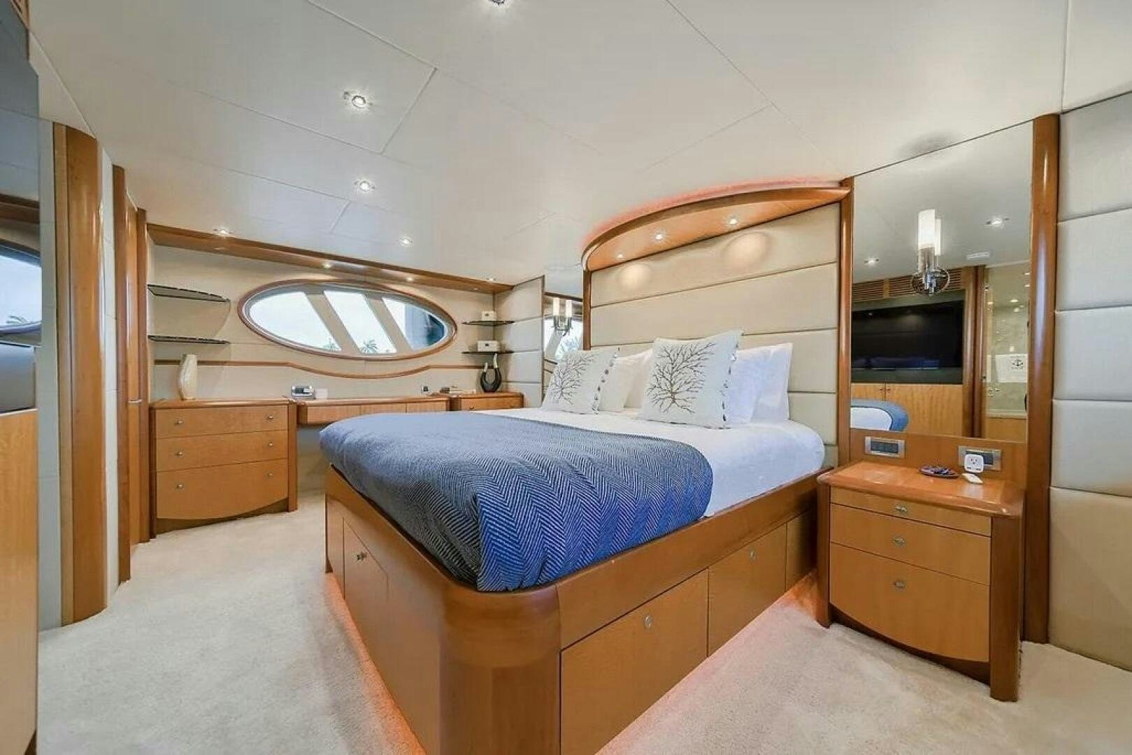 a bedroom with a bed and a mirror aboard CERCA TROVA Yacht for Sale