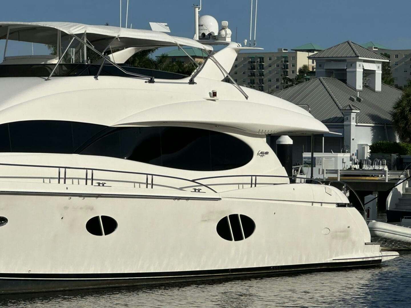 a white yacht in a harbor aboard CERCA TROVA Yacht for Sale