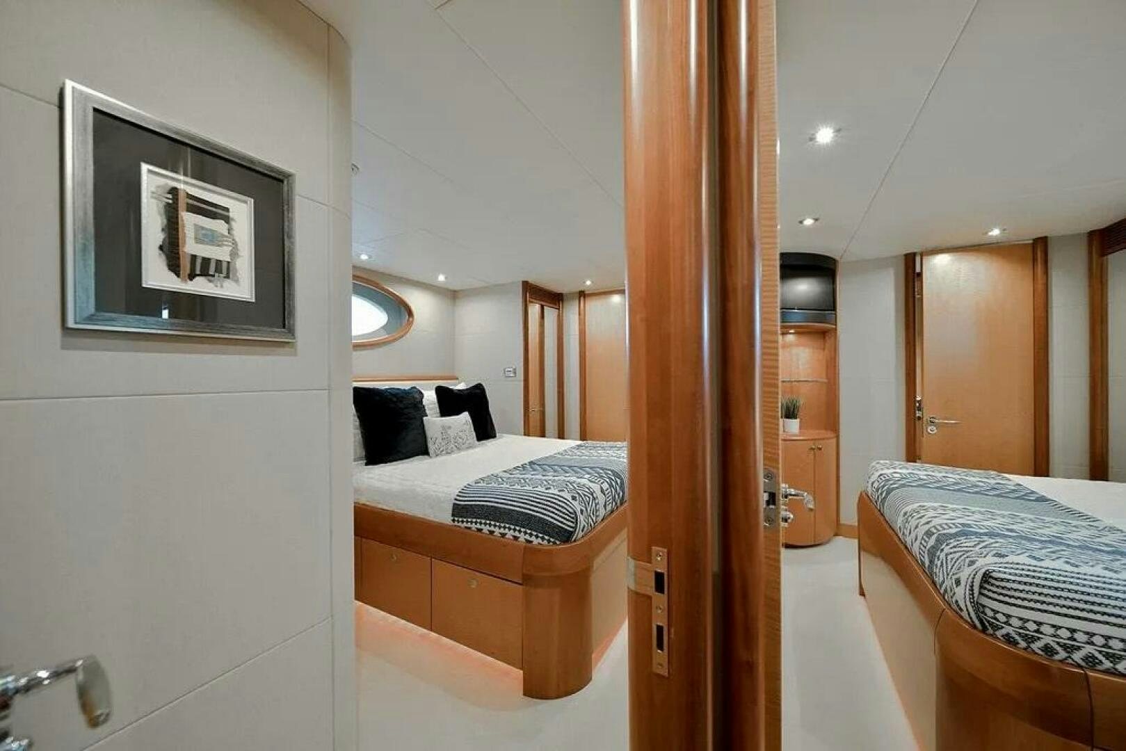 a bathroom with a bed and a mirror aboard CERCA TROVA Yacht for Sale