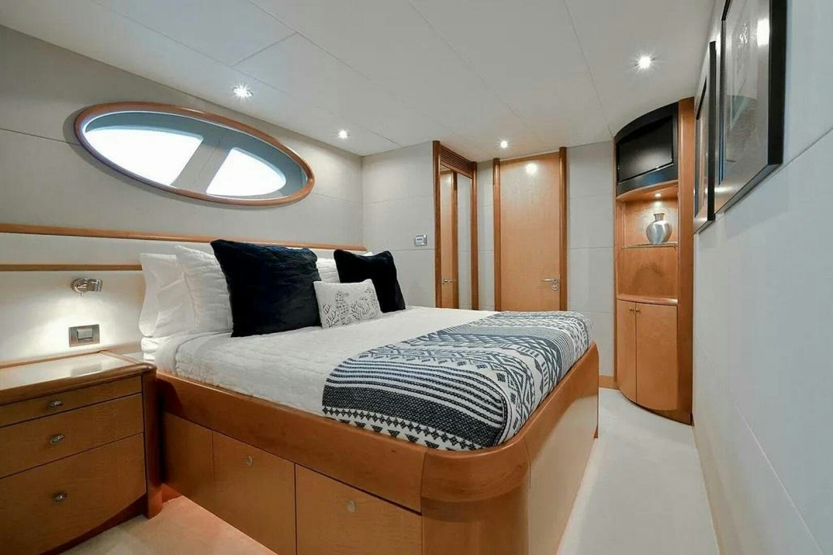 a bed with a white bed spread aboard CERCA TROVA Yacht for Sale