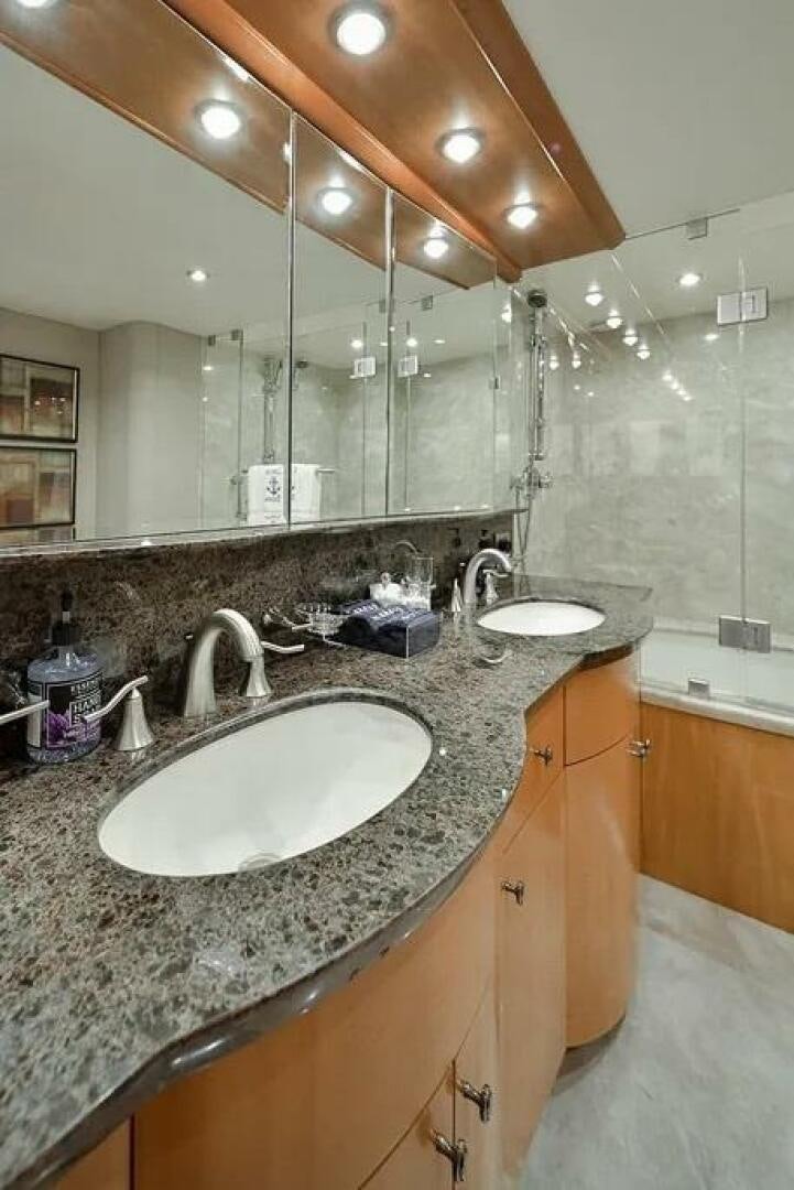 a bathroom with a large mirror aboard CERCA TROVA Yacht for Sale