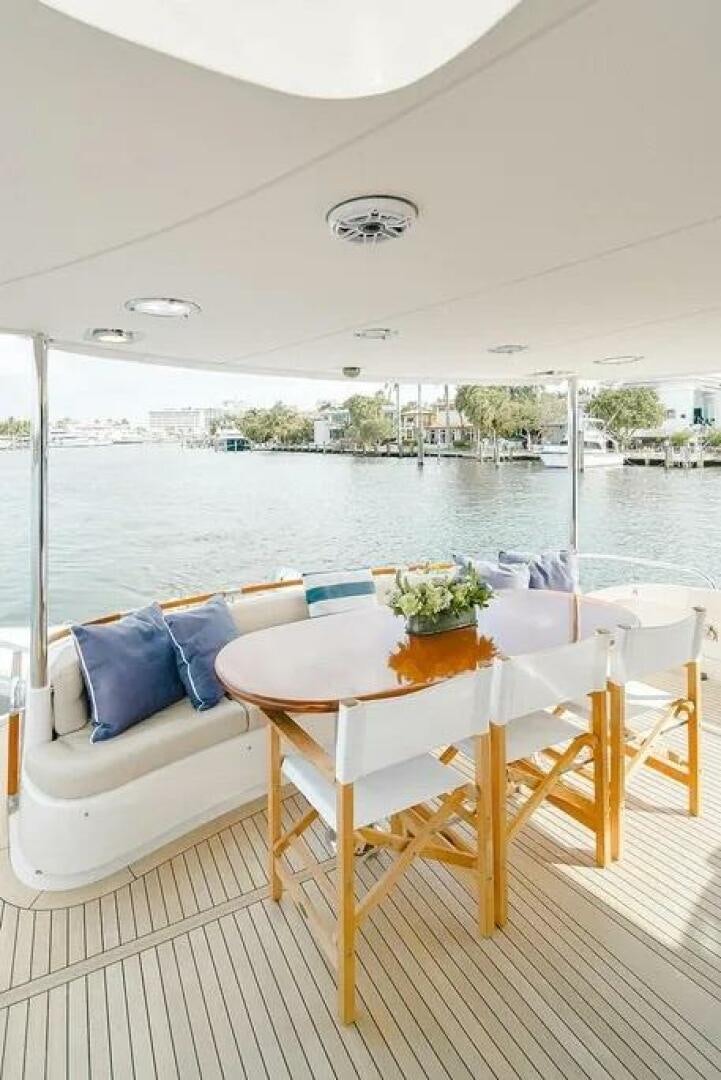 a table and chairs on a balcony aboard CERCA TROVA Yacht for Sale