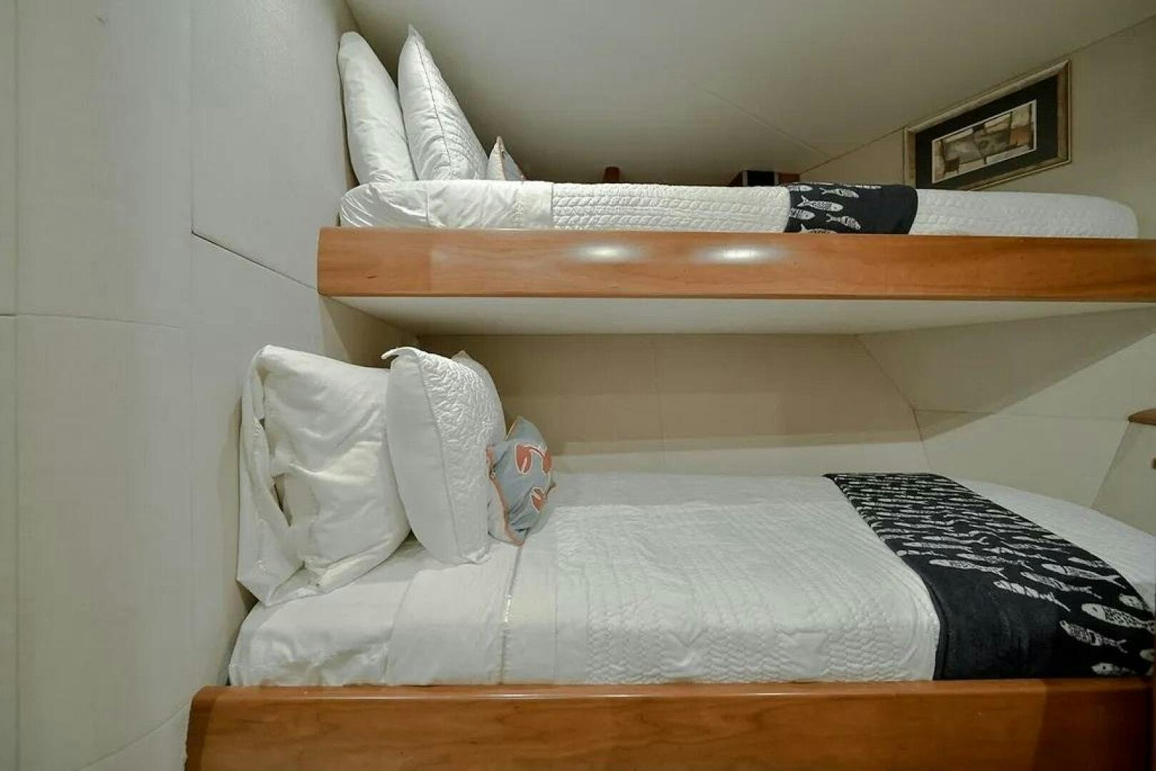 a bed with white pillows aboard CERCA TROVA Yacht for Sale