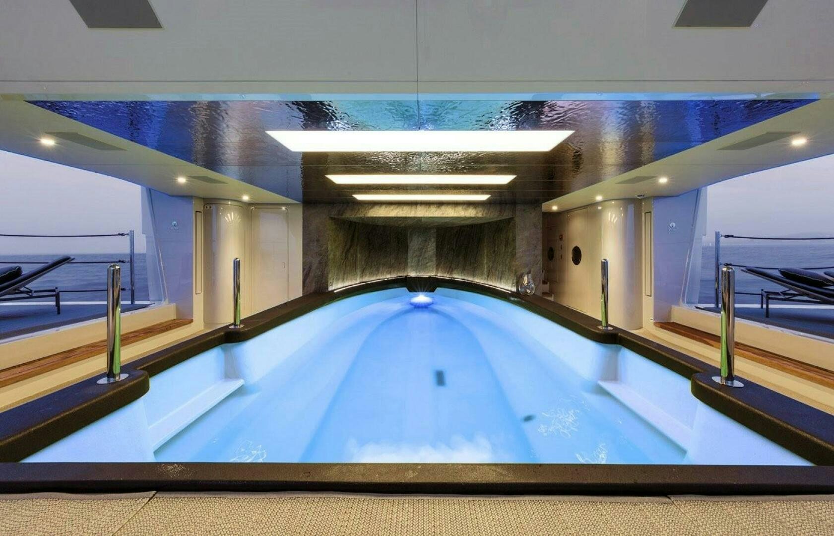 a swimming pool with glass walls aboard BARTALI Yacht for Sale