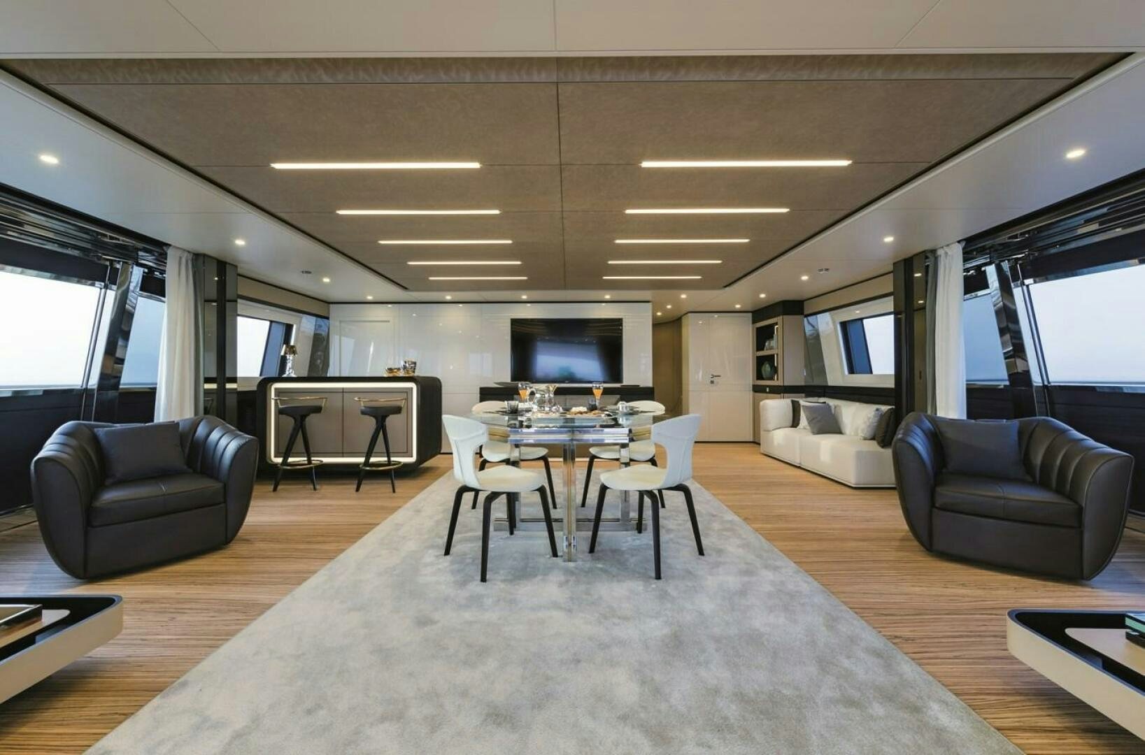 a living room with a large table and chairs aboard BARTALI Yacht for Sale