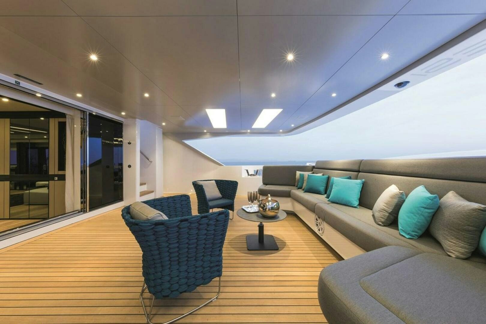 a living room with a large wood floor and a large window aboard BARTALI Yacht for Sale
