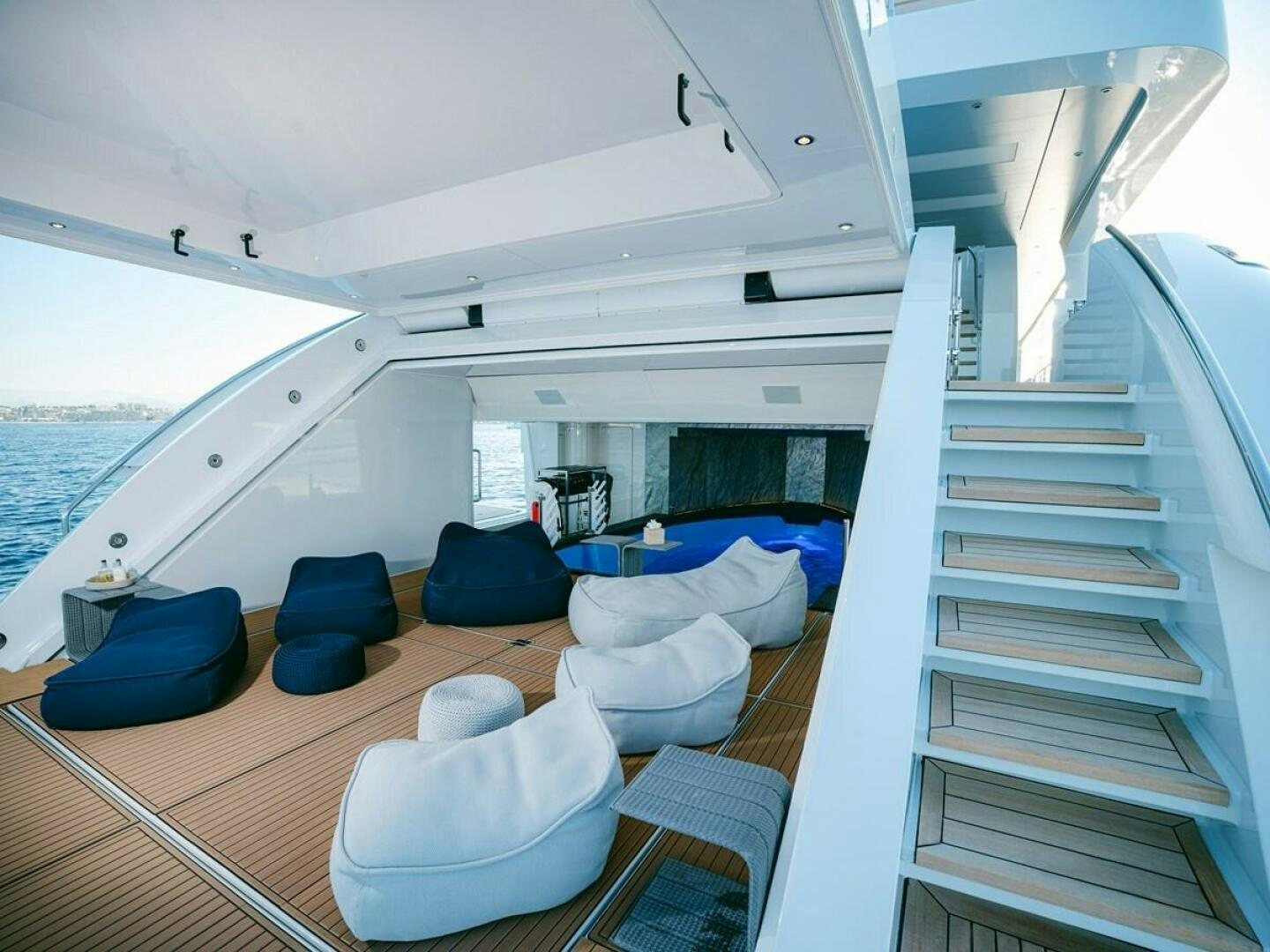 a boat with a staircase and chairs aboard BARTALI Yacht for Sale