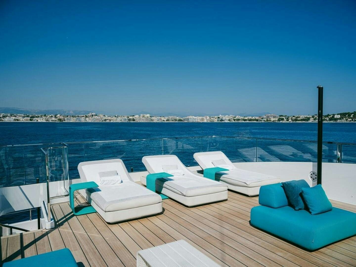 a deck with chairs and a view of a city aboard BARTALI Yacht for Sale
