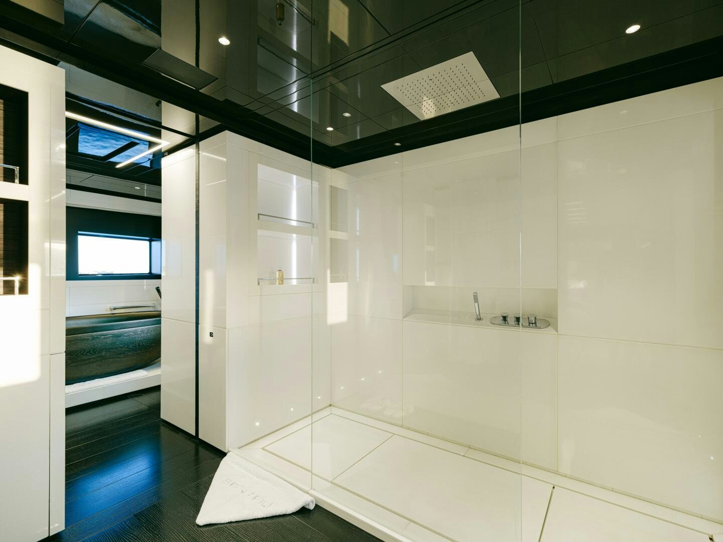 a room with a glass wall and a white tile floor aboard BARTALI Yacht for Sale