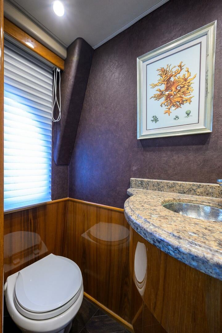 a bathroom with a painting on the wall aboard JUST CHILLIN Yacht for Sale
