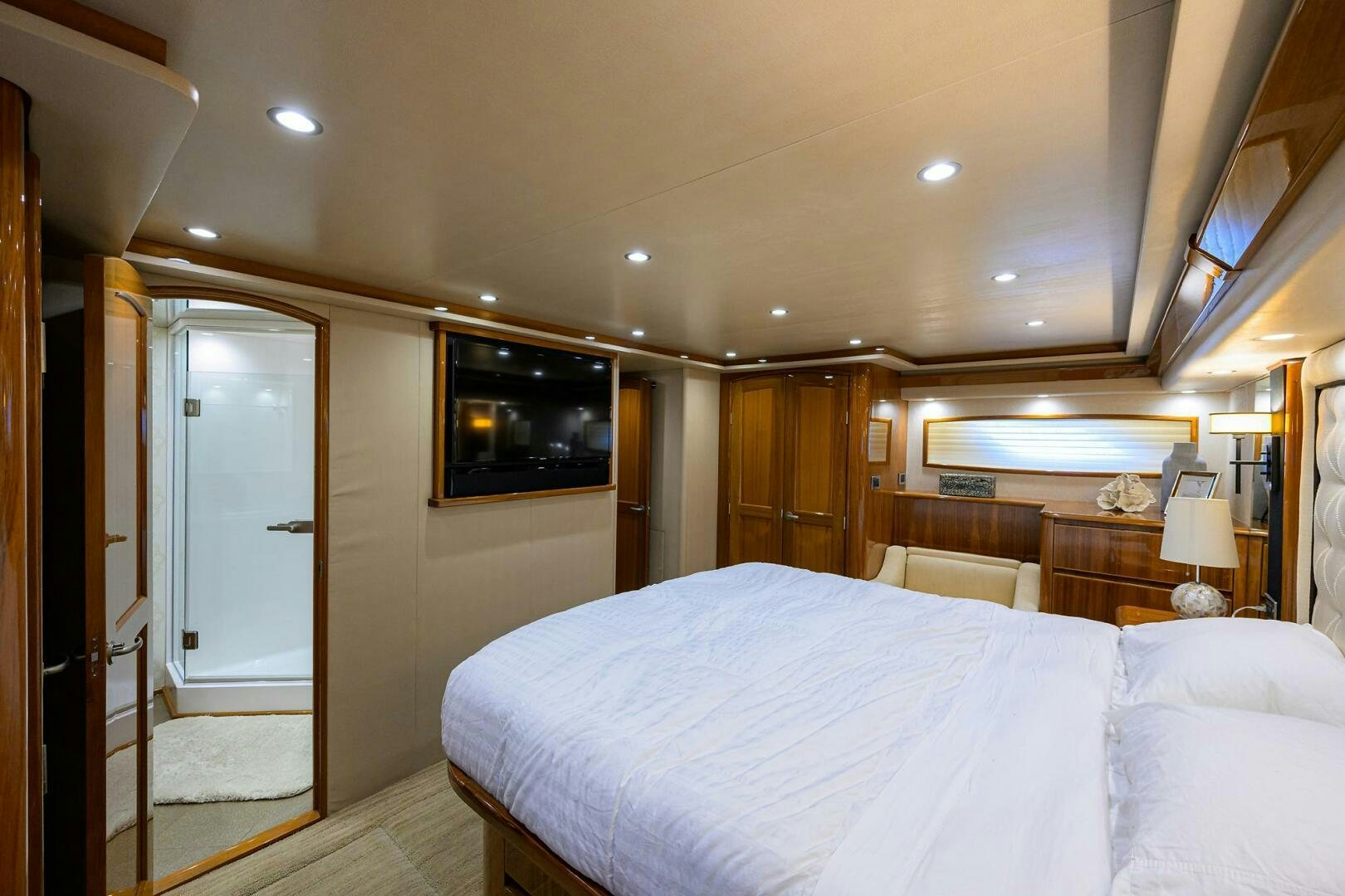 a bedroom with a bed and a television aboard JUST CHILLIN Yacht for Sale