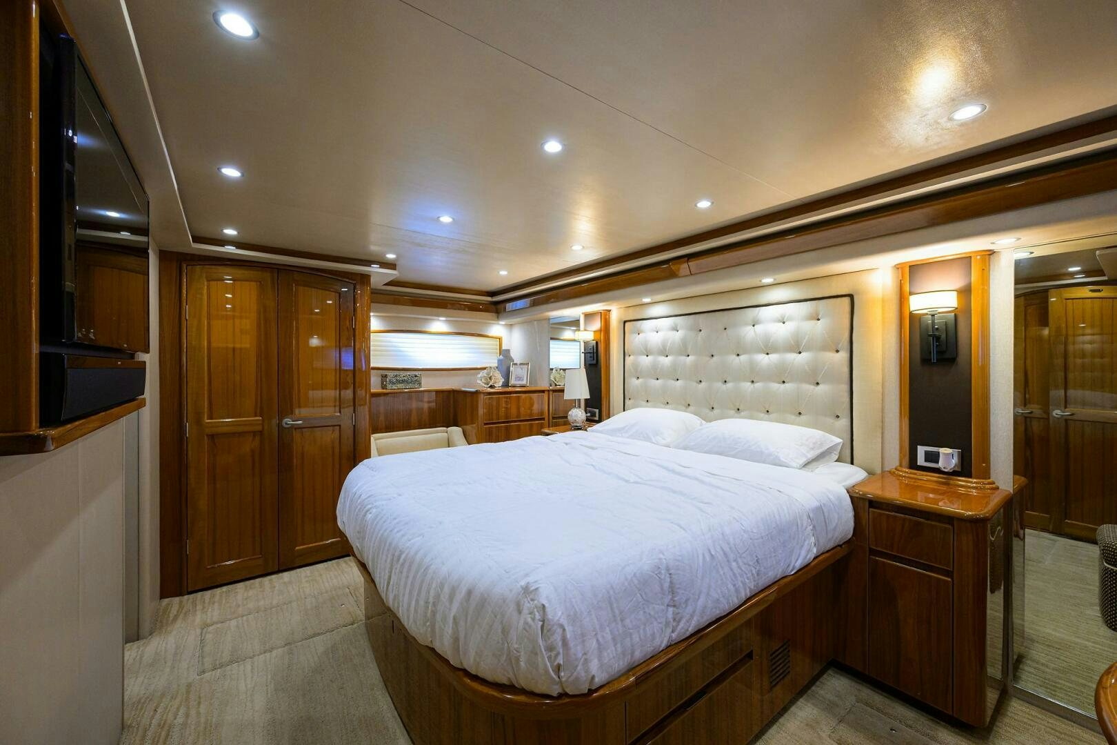 a bedroom with a bed and a dresser aboard JUST CHILLIN Yacht for Sale