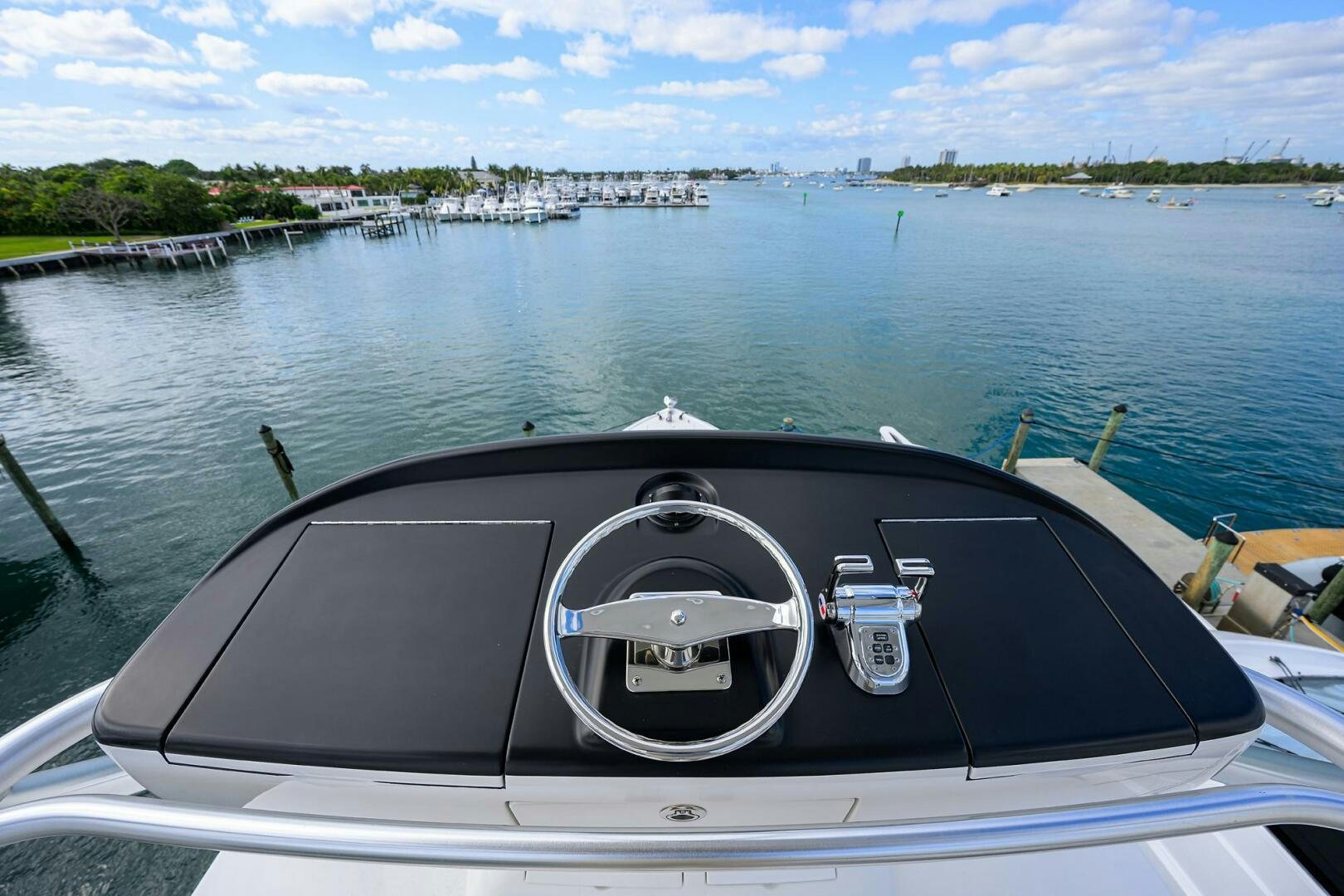 a boat with a steering wheel and a view of a city aboard JUST CHILLIN Yacht for Sale