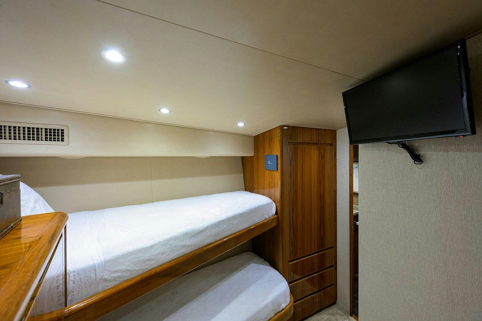 a bedroom with a tv on the wall aboard JUST CHILLIN Yacht for Sale
