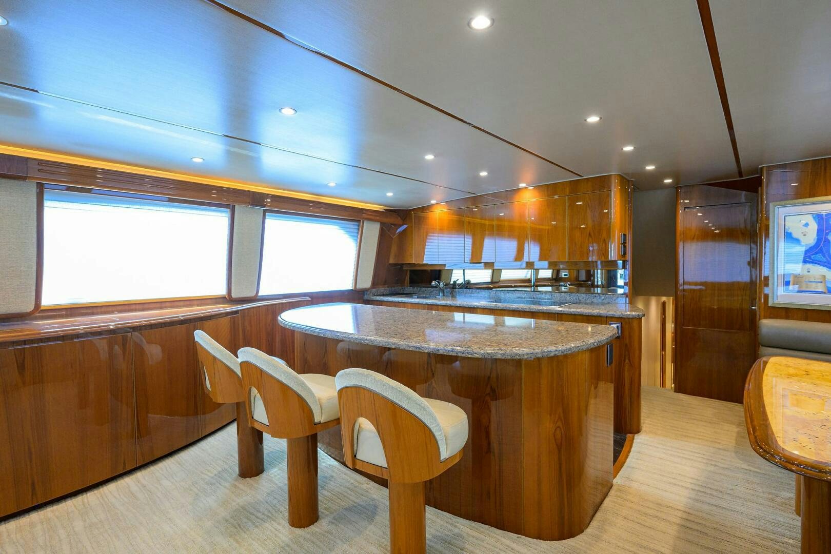 a large kitchen with a bar and a table aboard JUST CHILLIN Yacht for Sale