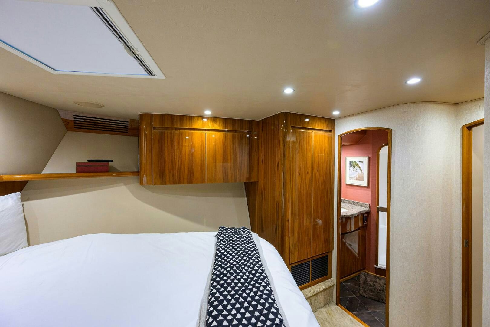a bedroom with a bed and a closet aboard JUST CHILLIN Yacht for Sale