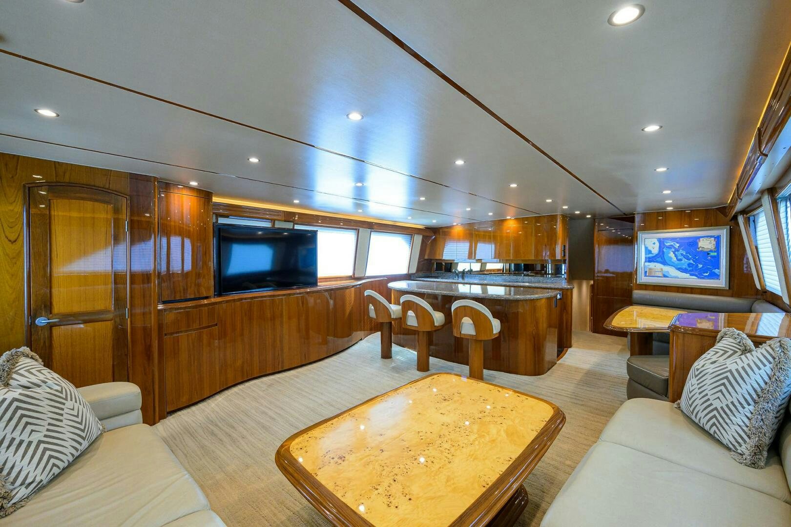 a living room with a large wood table and a large tv aboard JUST CHILLIN Yacht for Sale