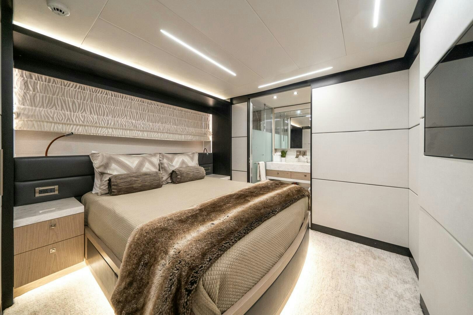 a bedroom with a bed and a mirror aboard DAY ONE Yacht for Sale