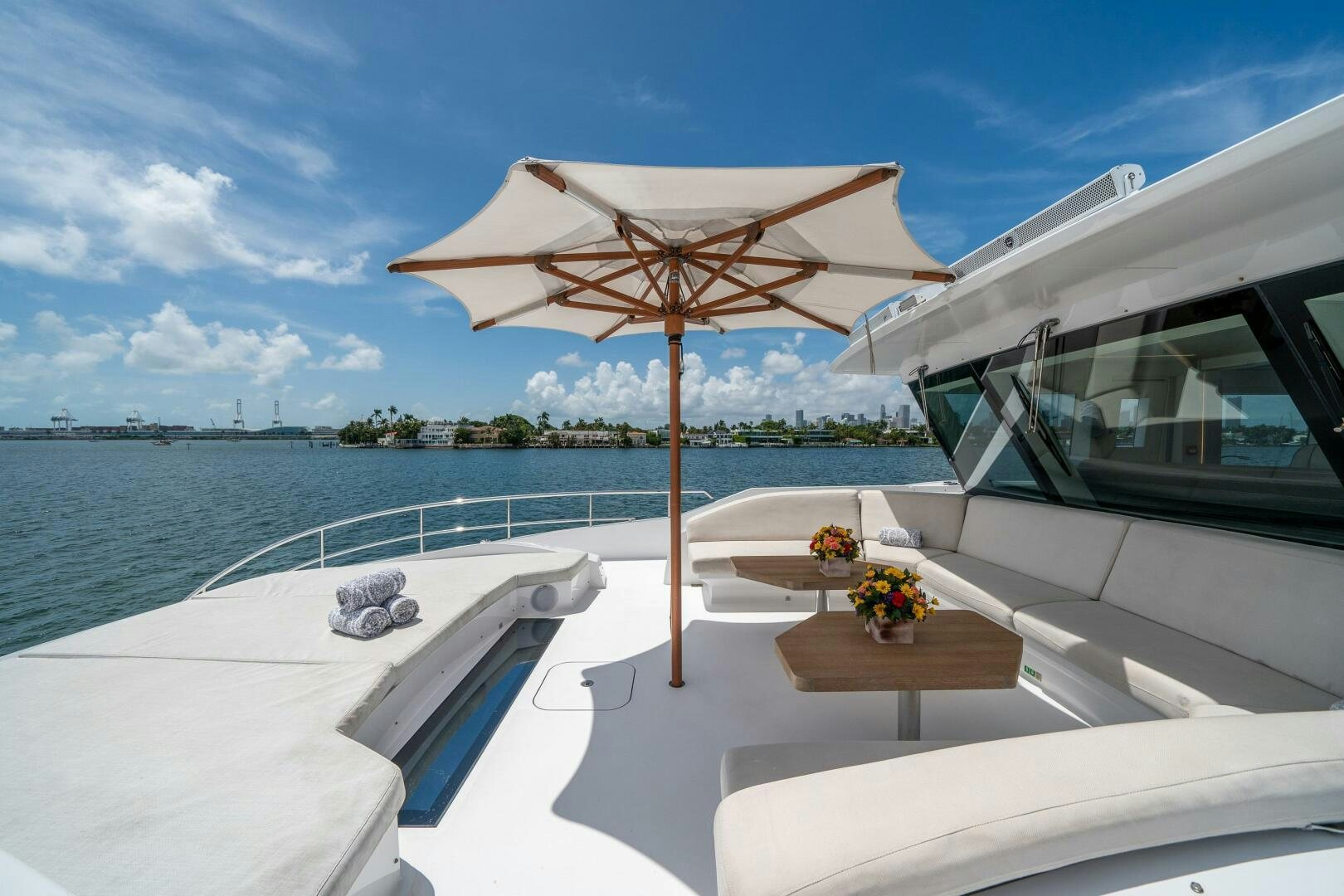 a lounge chair and umbrella on a boat aboard DAY ONE Yacht for Sale