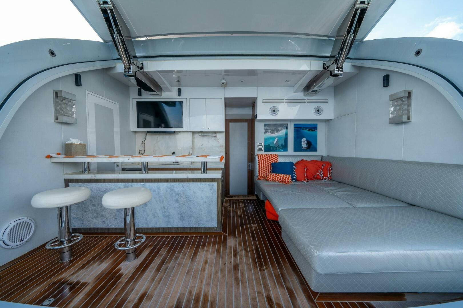 a room with a bed and stools aboard DAY ONE Yacht for Sale