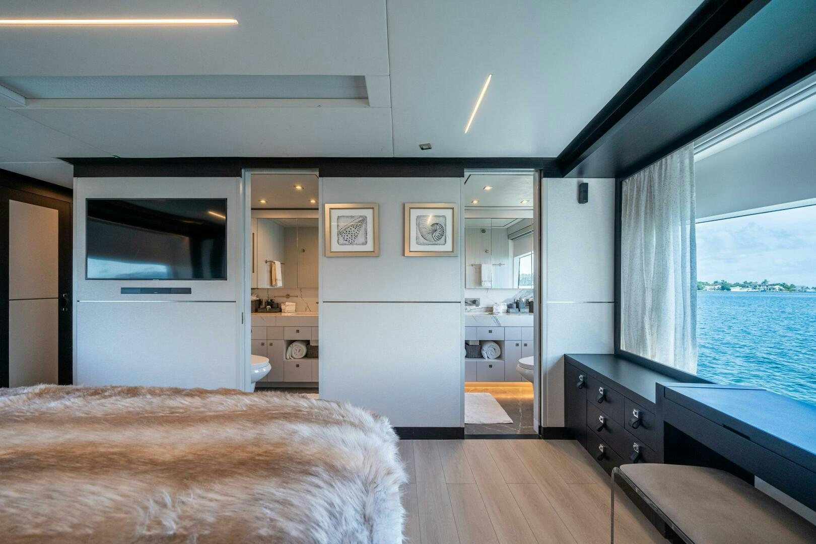 a bedroom with a large window aboard DAY ONE Yacht for Sale