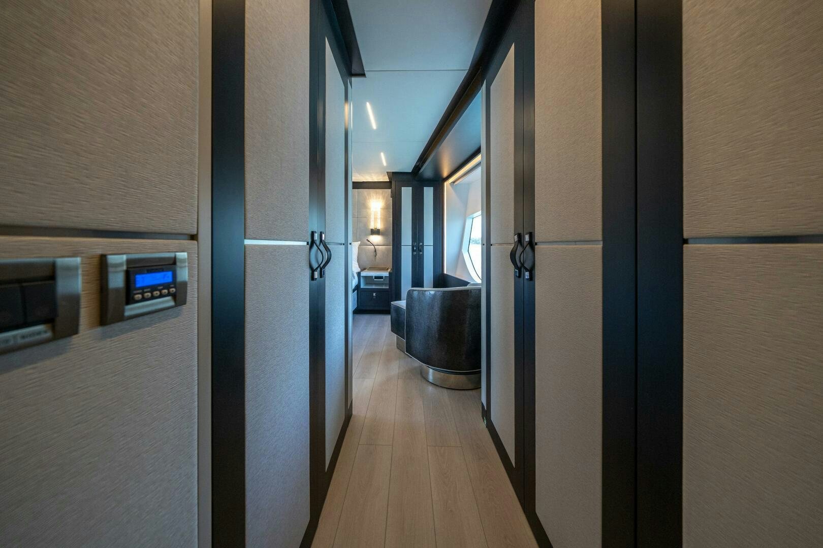 a hallway with a wood floor and a door with a window aboard DAY ONE Yacht for Sale