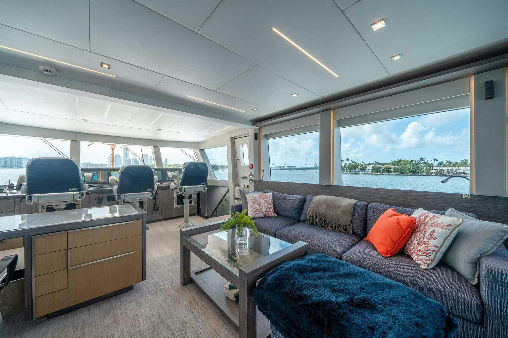 a living room with a couch and a table aboard DAY ONE Yacht for Sale