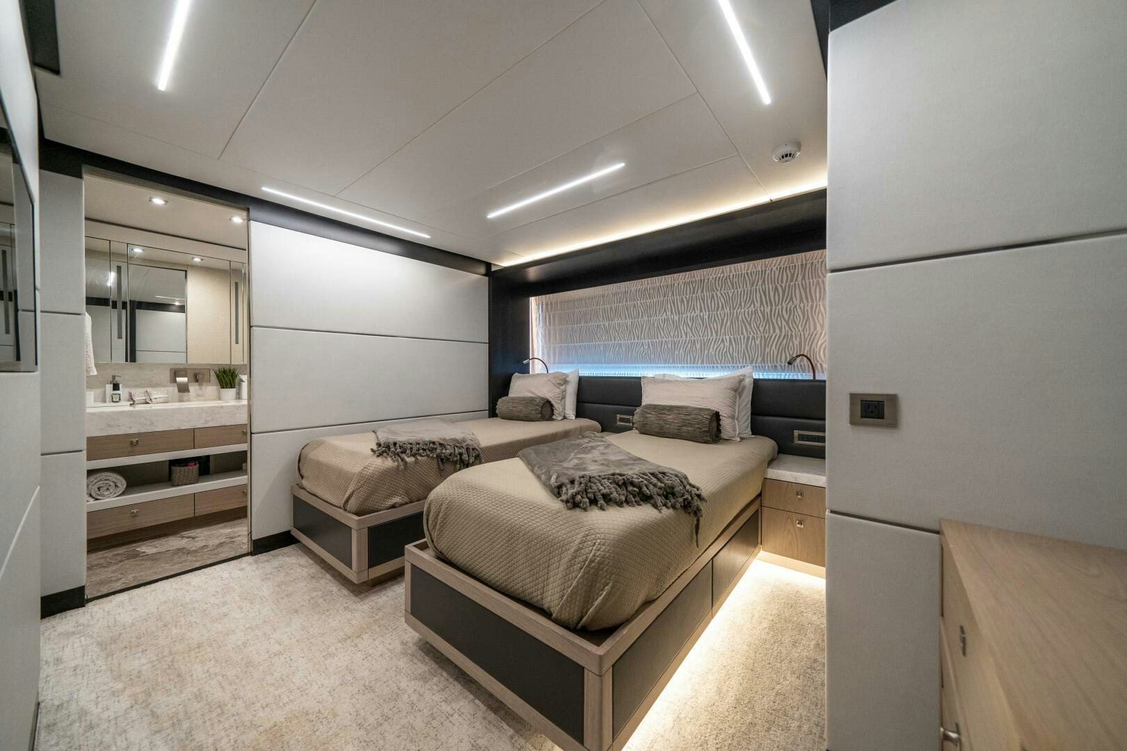 a bedroom with a bed and a mirror aboard DAY ONE Yacht for Sale