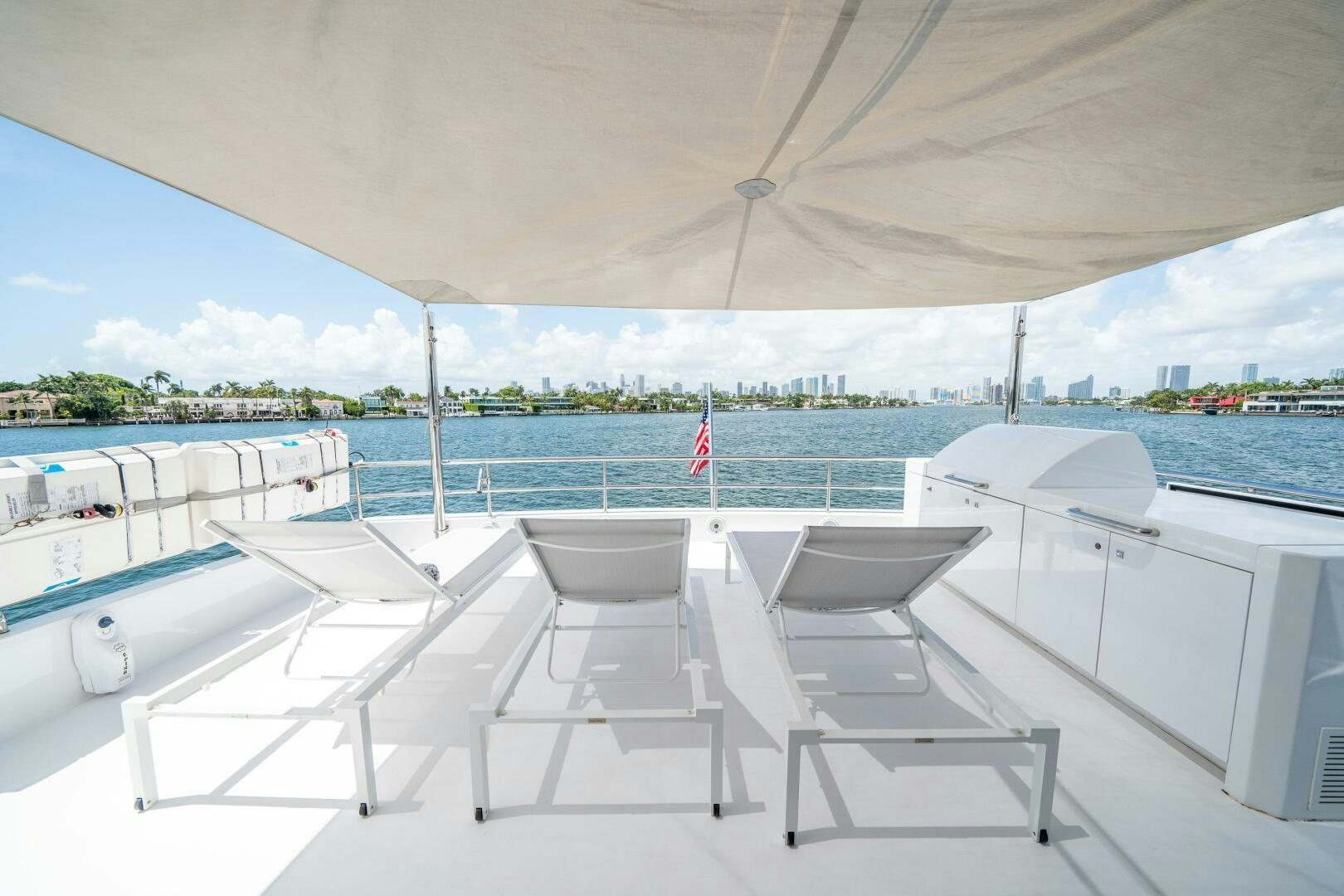 a white table and chairs on a boat aboard DAY ONE Yacht for Sale