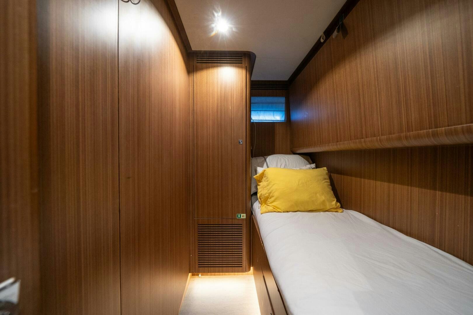 a room with a bed and a wood door aboard DAY ONE Yacht for Sale