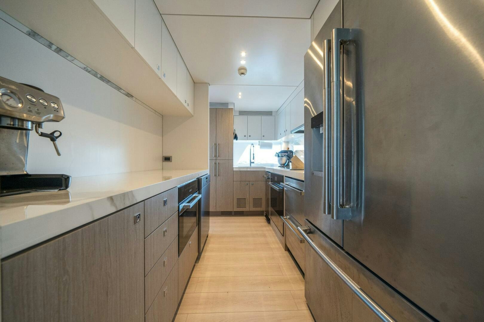 a kitchen with stainless steel appliances aboard DAY ONE Yacht for Sale