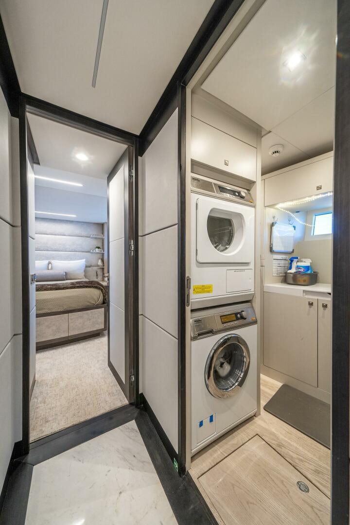 a laundry room with a washer and dryer aboard DAY ONE Yacht for Sale